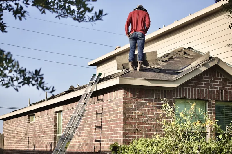 Professional roofer working on a residential roof in New Trenton